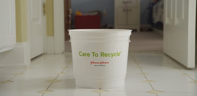 A bucket labelled Care to Recycle on the floor